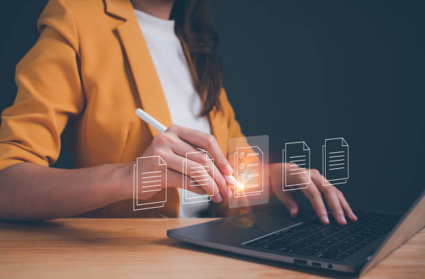 businesswoman working on laptop with electronics document ic (1)