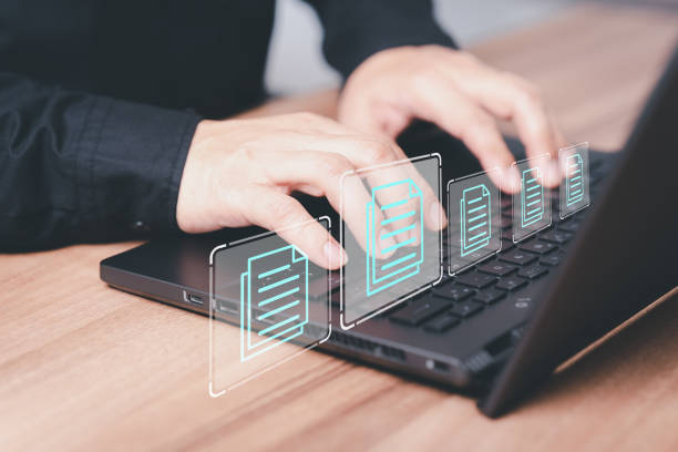 employee typing on a computer keyboard checking documents in
